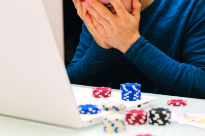 young man playing with his computer on gambling websites. online casino poker roulette. Lifestyle. Winner or bankrupt by becoming a millionaire.